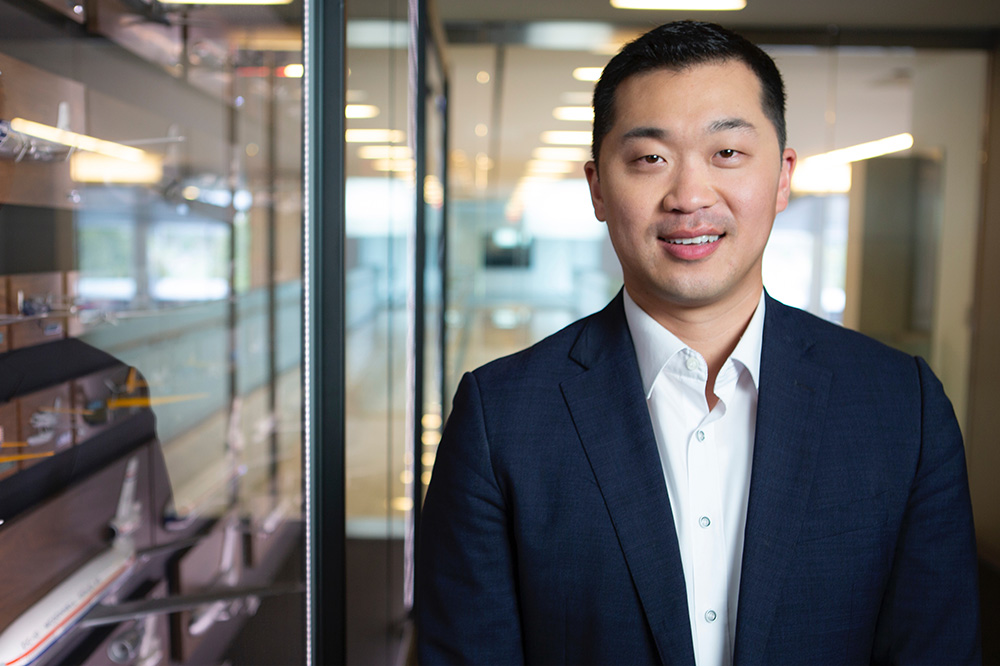 Jason Pak, Senior Director of Government Affairs & Defense at Hanwha USA Corporate Affairs, smiling in an office setting.