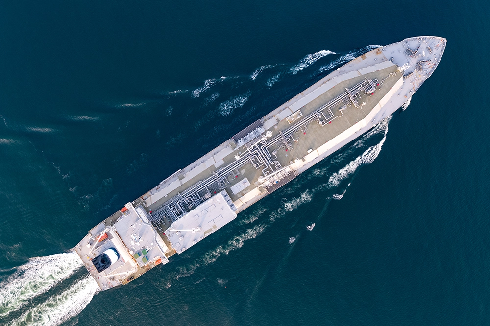 Overhead view of a liquefied natural gas carrier navigating through open water.