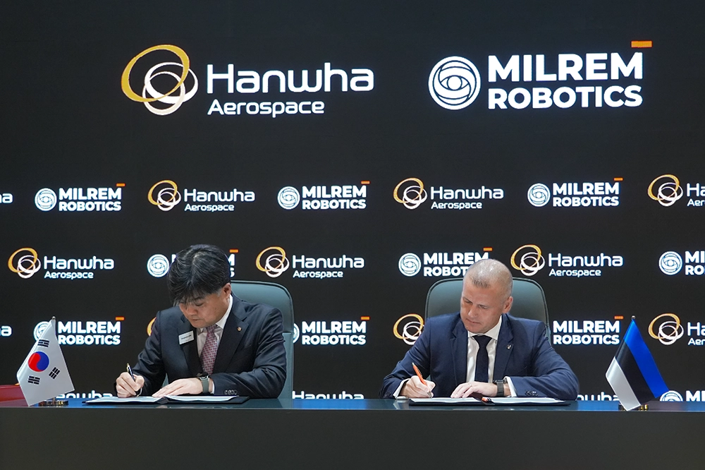 Hanwha Aerospace and Milrem Robotics executives sign a Memorandum of Understanding to co-develop robotic combat vehicles.