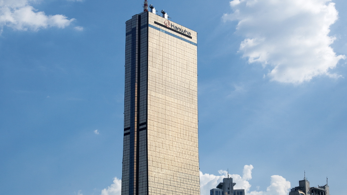 The tall, golden-colored 63 Building in Seoul, Korea, seen from a distance on a sunny day