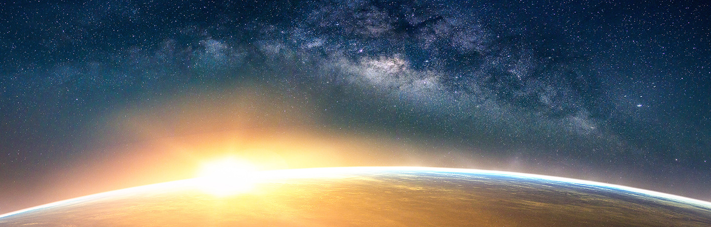 Earth illuminated by the rising sun as seen from outer space.