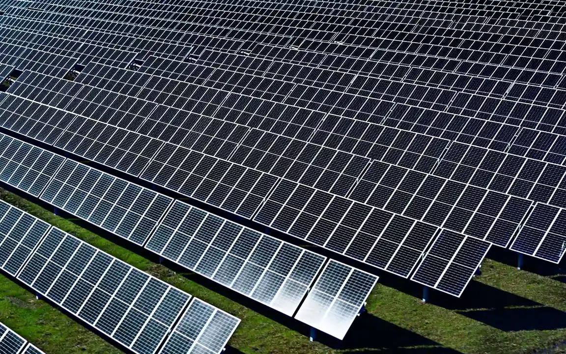 Rows of Hanwha Qcells’ solar panels installed on a field, showcasing renewable energy innovation.