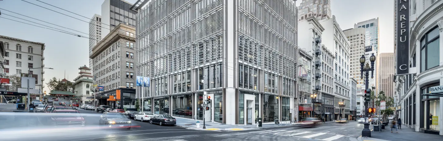 Hanwha AI Center, a modern building, pictured on a bustling San Francisco street